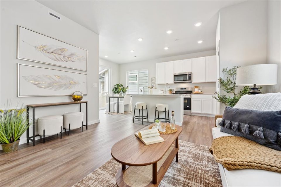 A large living room with a wood floor and a wood floor.