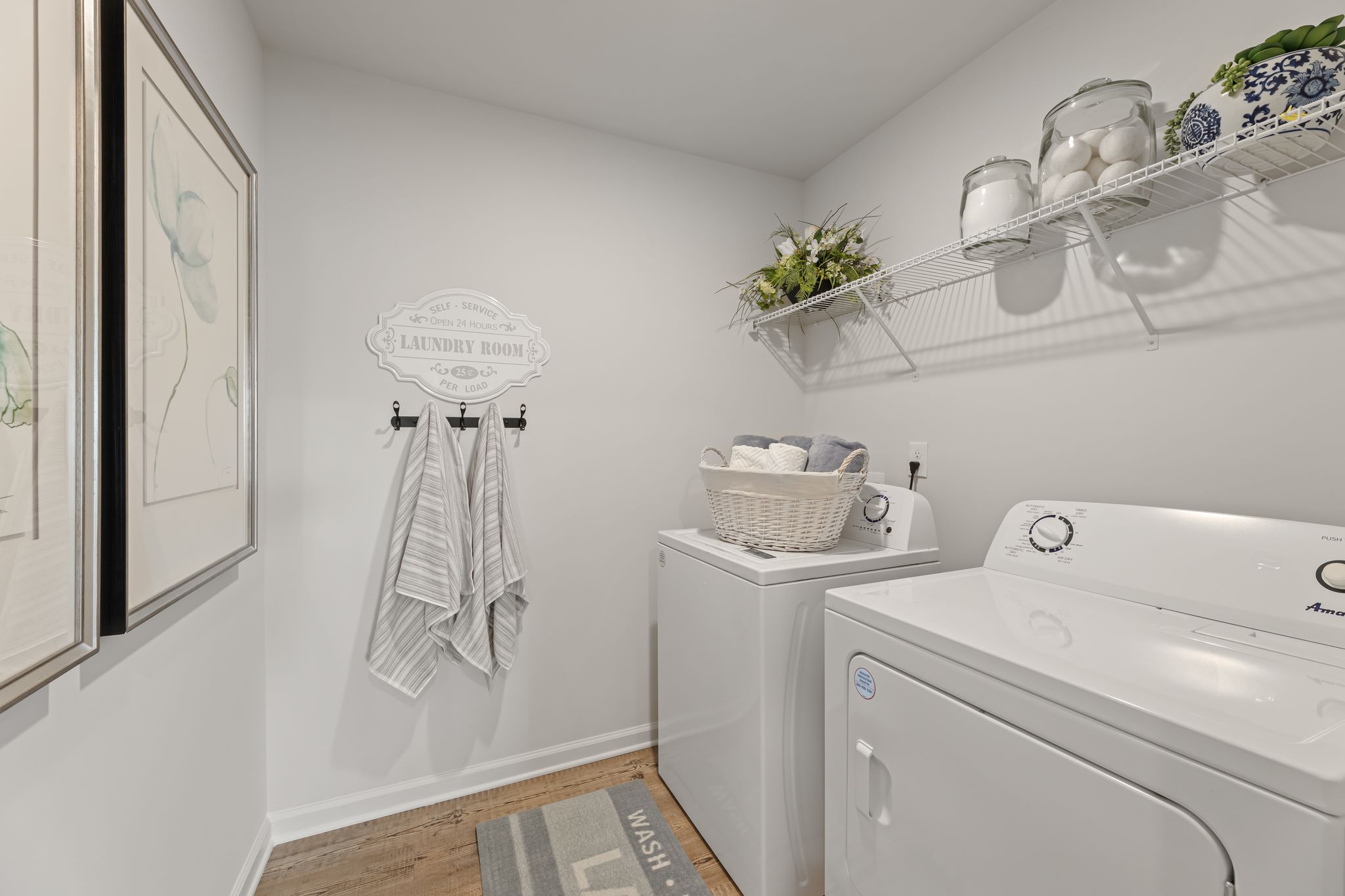 A bathroom with a sink and a shelf with a towel from it.
