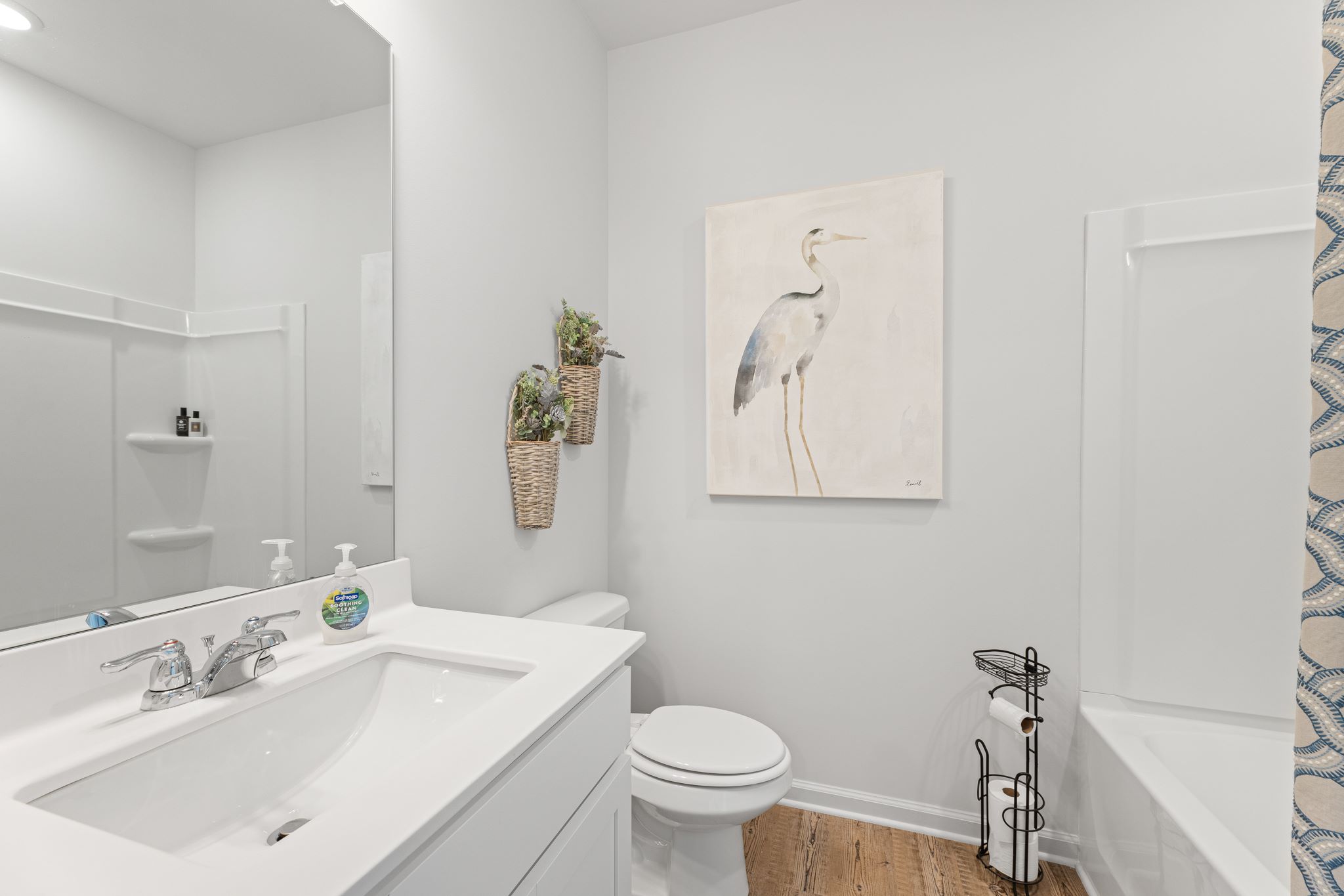 A bathroom with a sink toilet and a shower.
