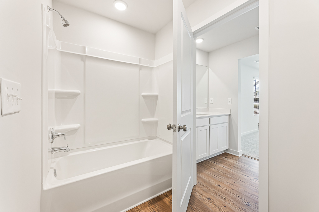 A bathroom with a tub and sink.