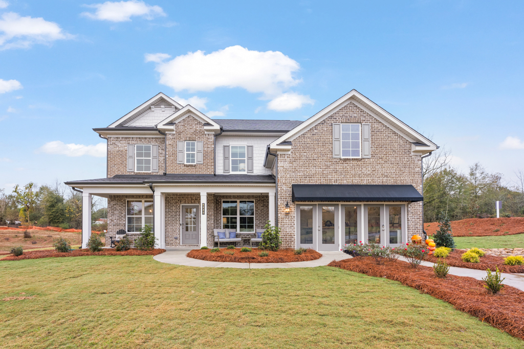 A large house with a lawn.