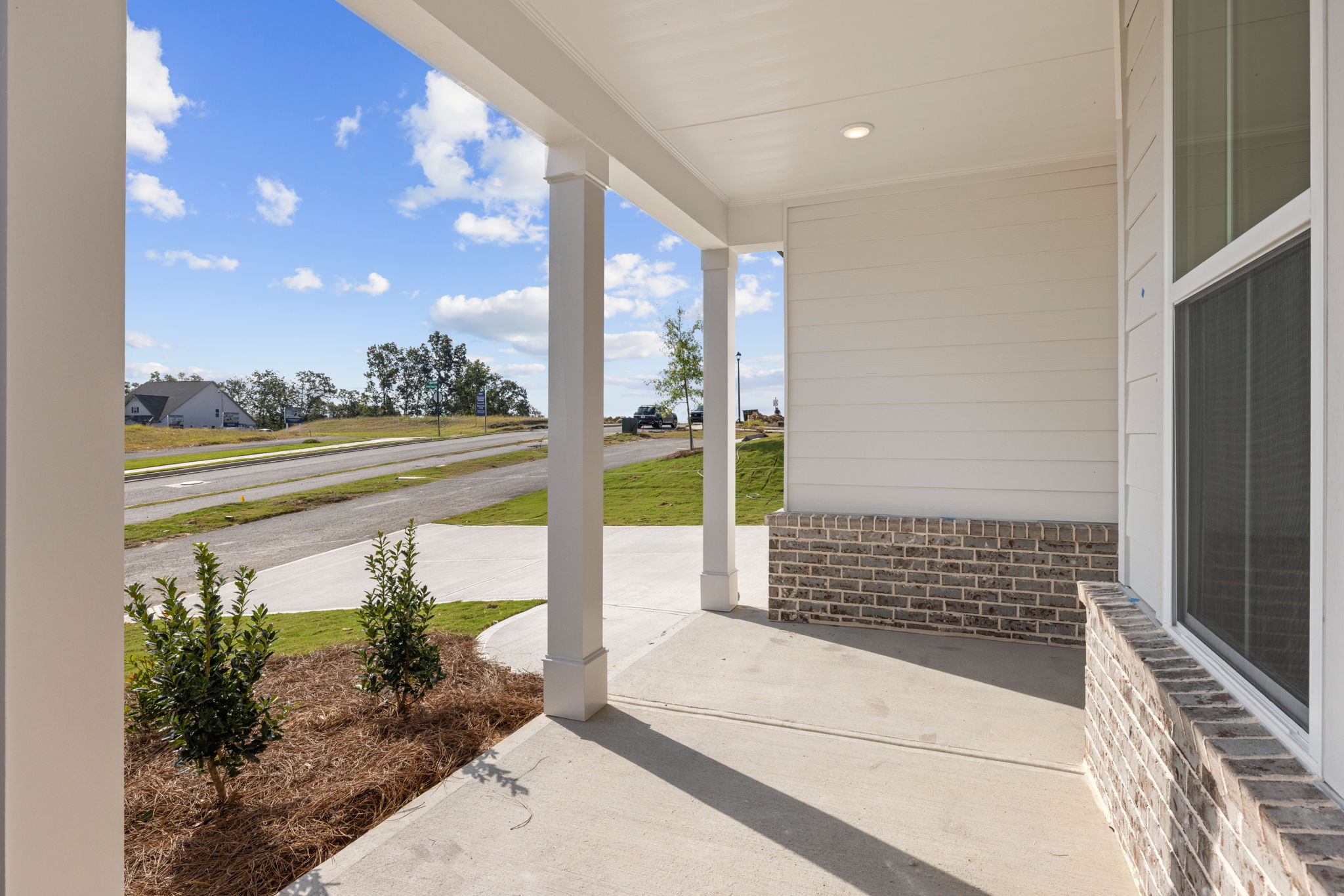 A building with a walkway and grass.