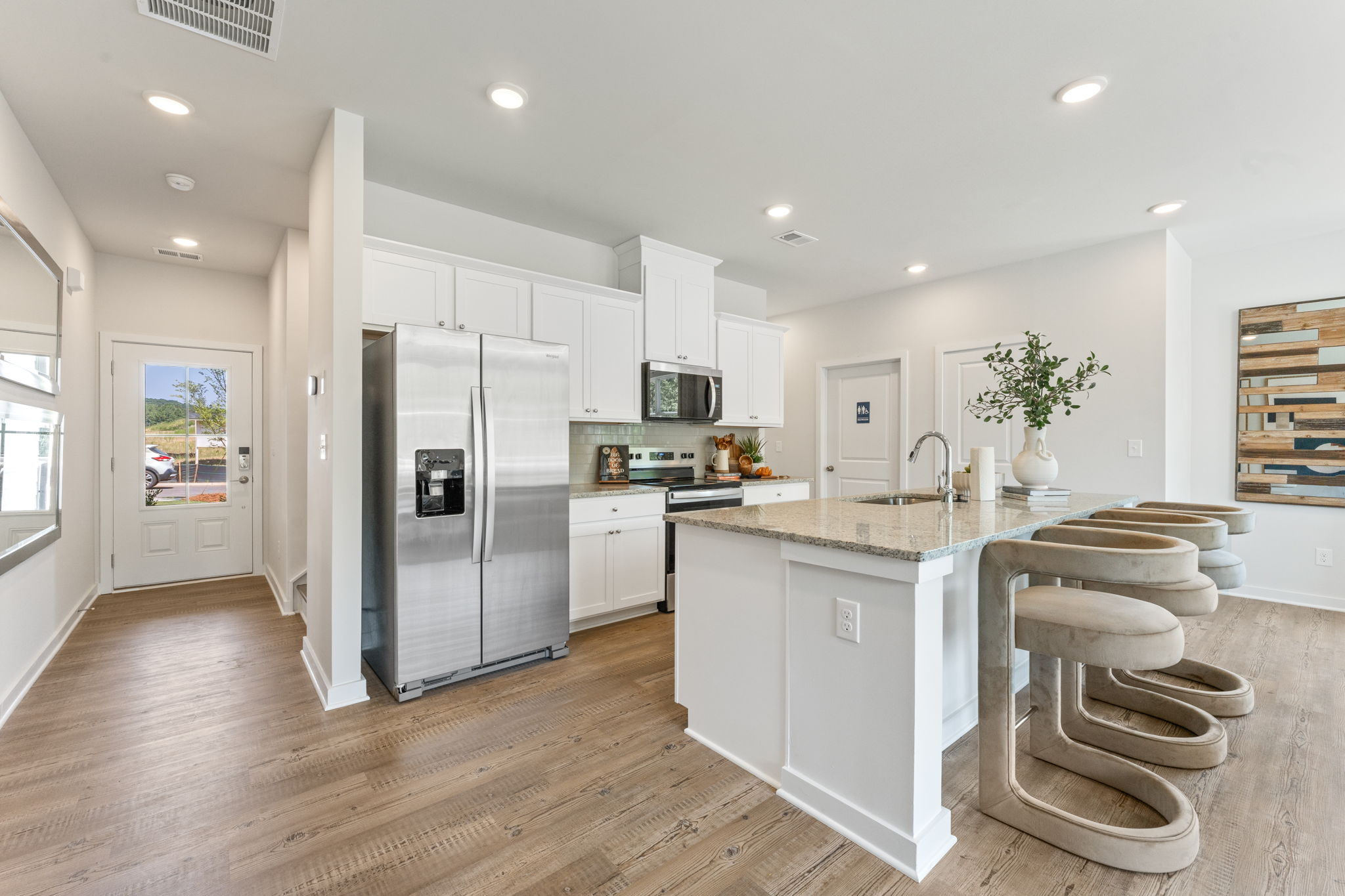 A kitchen with white cabinets.