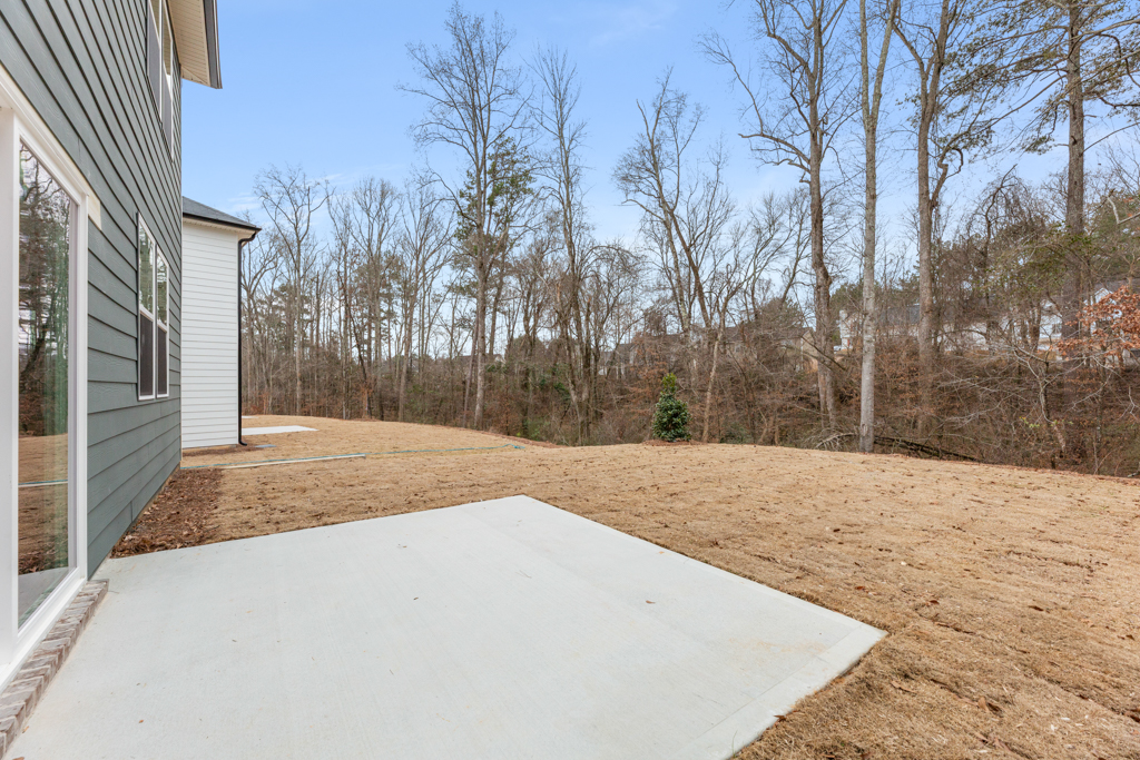 A dirt path next to a house.