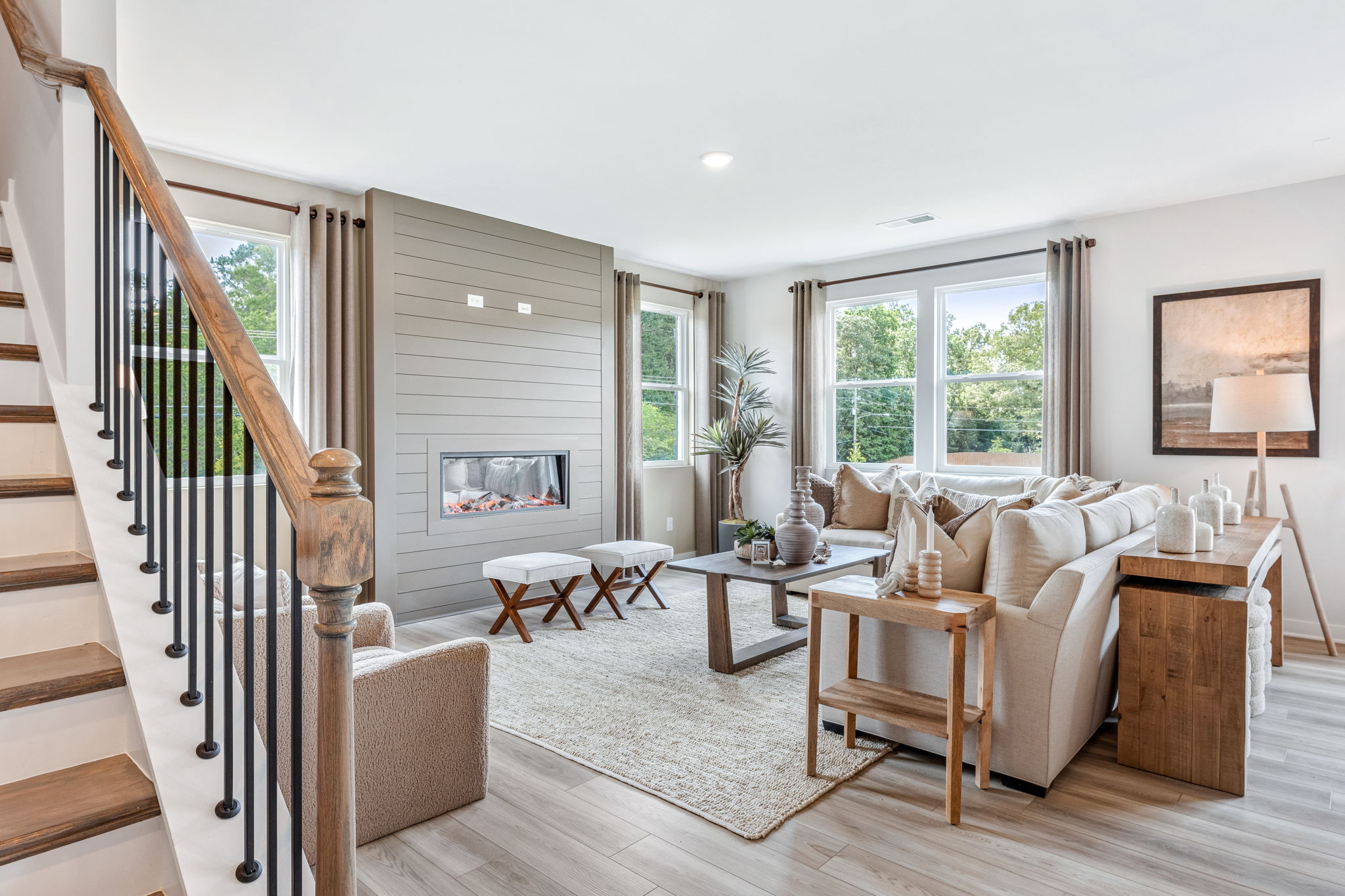 A living room with a staircase.