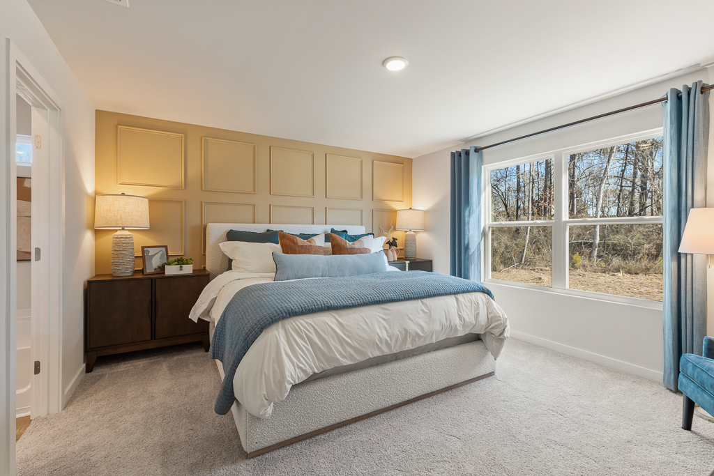 A bedroom with a bed and lamps.