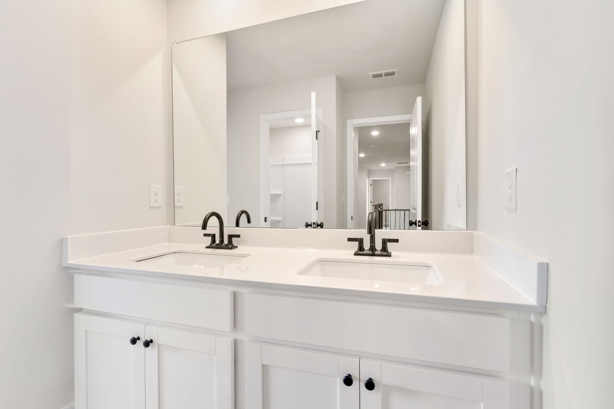 A bathroom with a large mirror.
