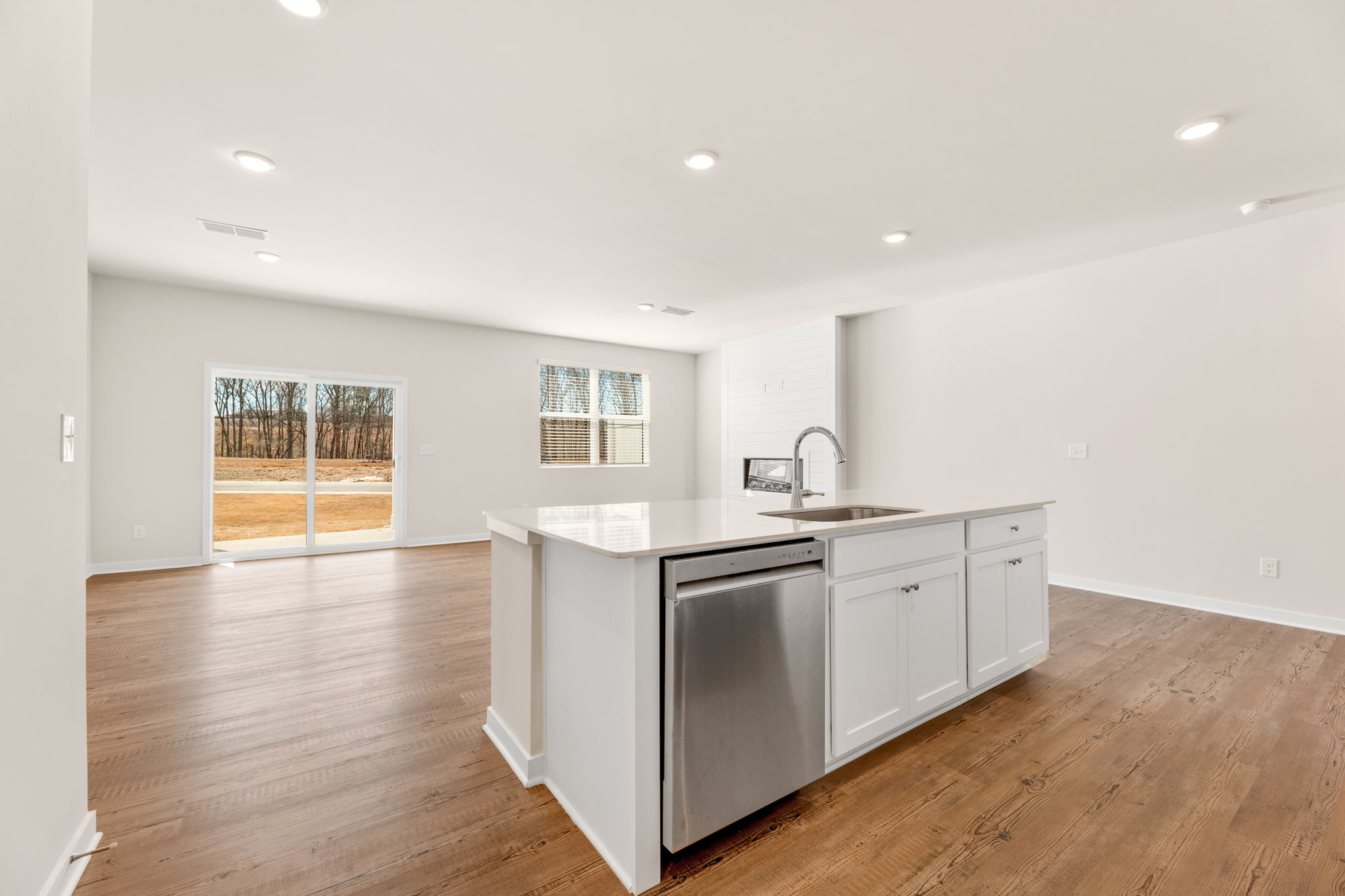 A kitchen with white cabinets.