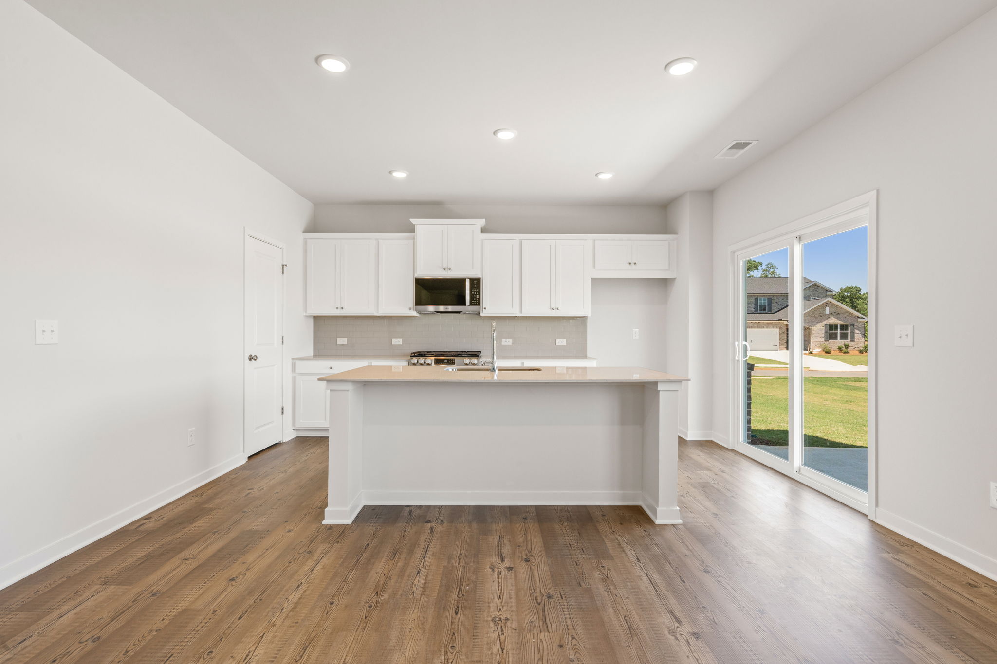 A kitchen with white cabinets.