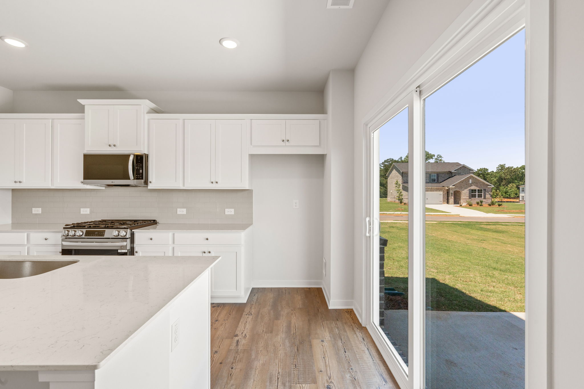 A kitchen with white cabinets.