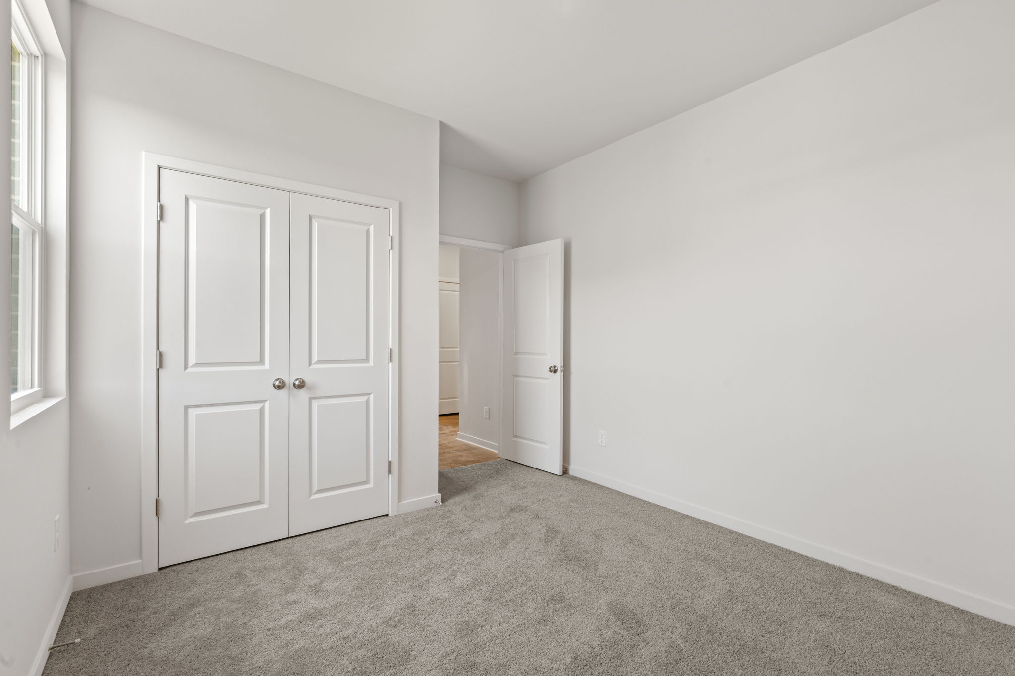 A hallway with white doors.
