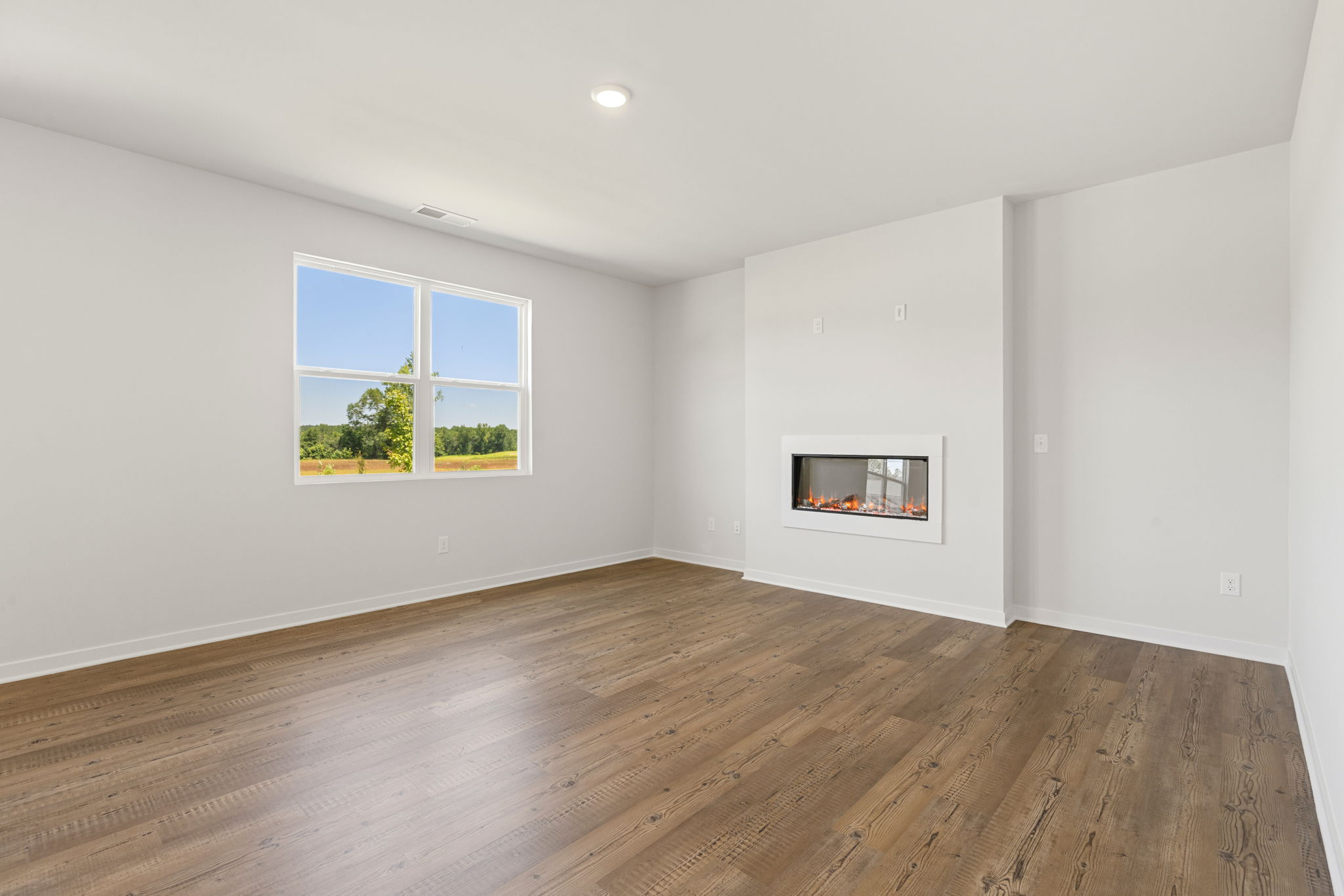 A room with a wood floor and a window with a wood floor.