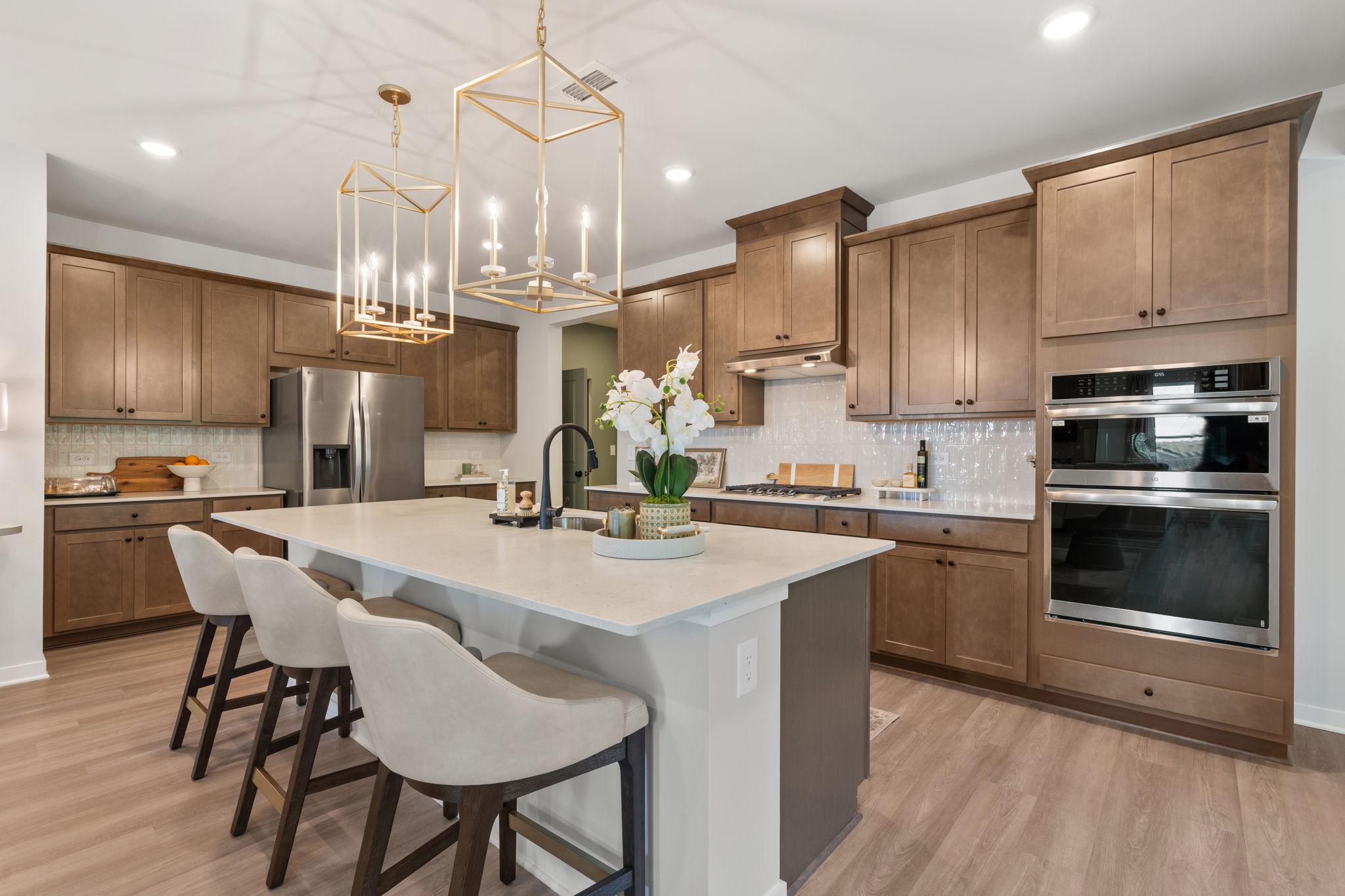 A kitchen with a chandelier and a dining table.