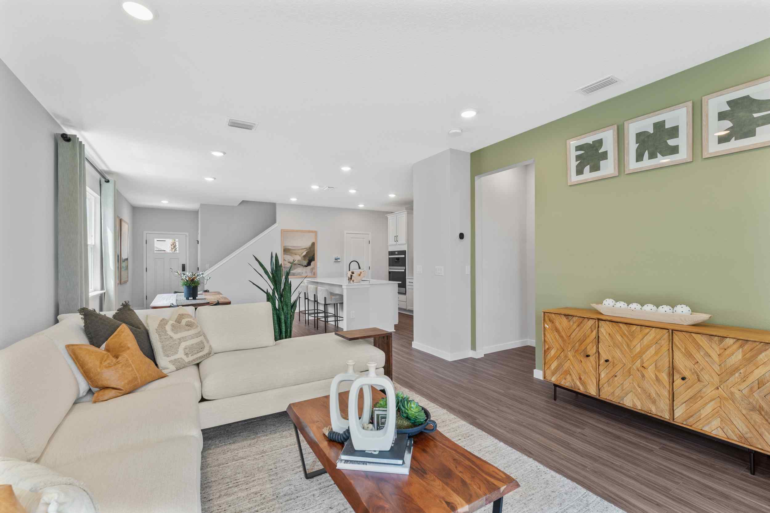 Silverbell II Model Home Living Room in Front of Dining Area and Kitchen at Camden Woods in Kingsland, GA