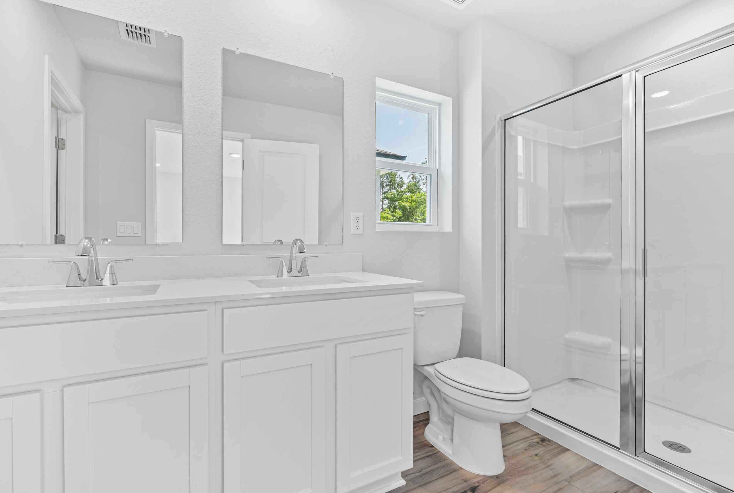 Davor Paired Home Primary Bath with Shower and Dual Vanities at The Landings at Pecan Park in Jacksonville