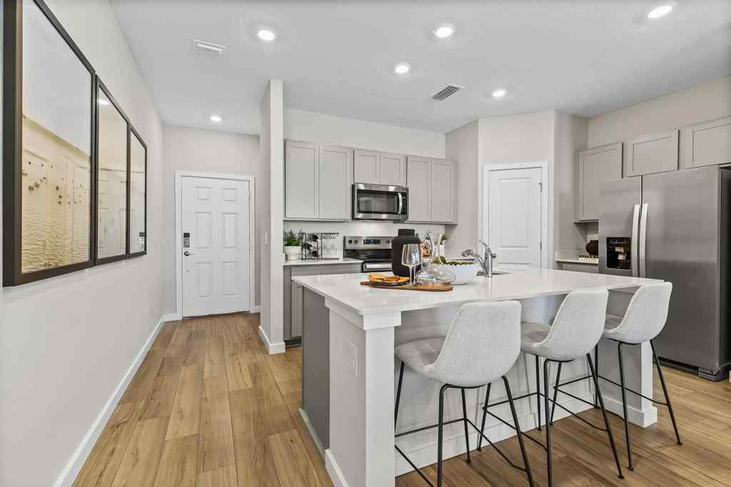 A kitchen with white cabinets.