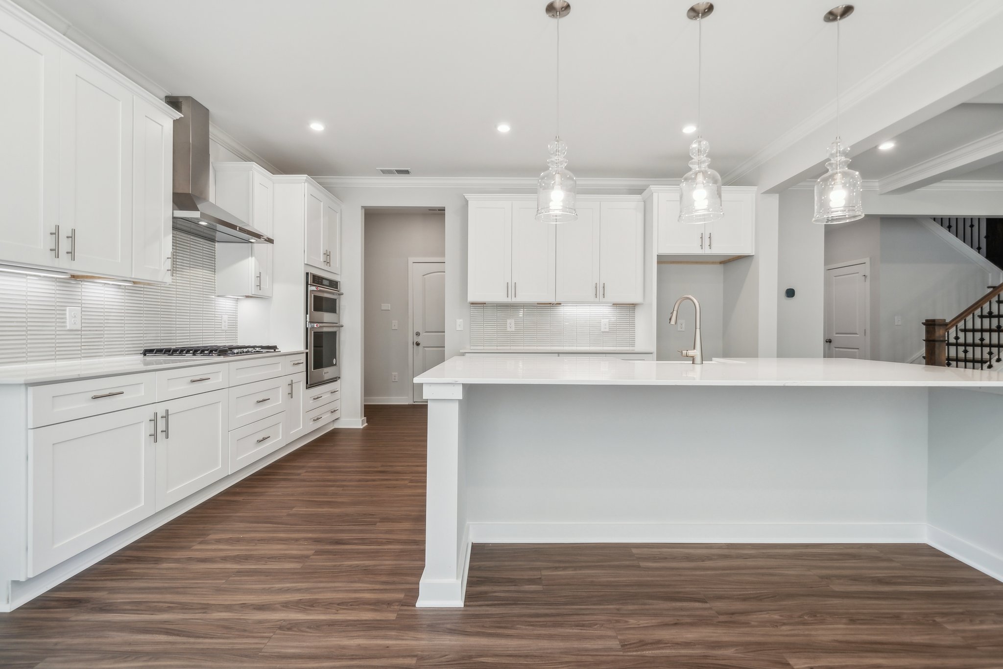 A kitchen with white cabinets.