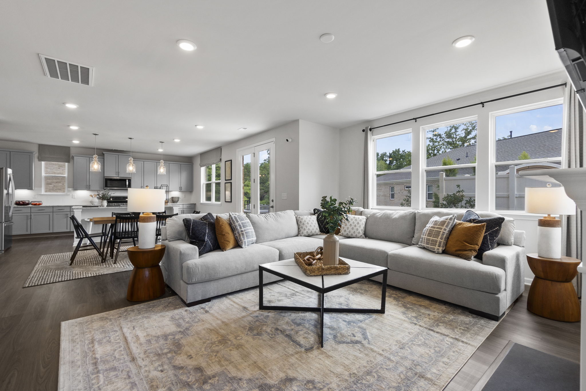 A living room with a large rug.