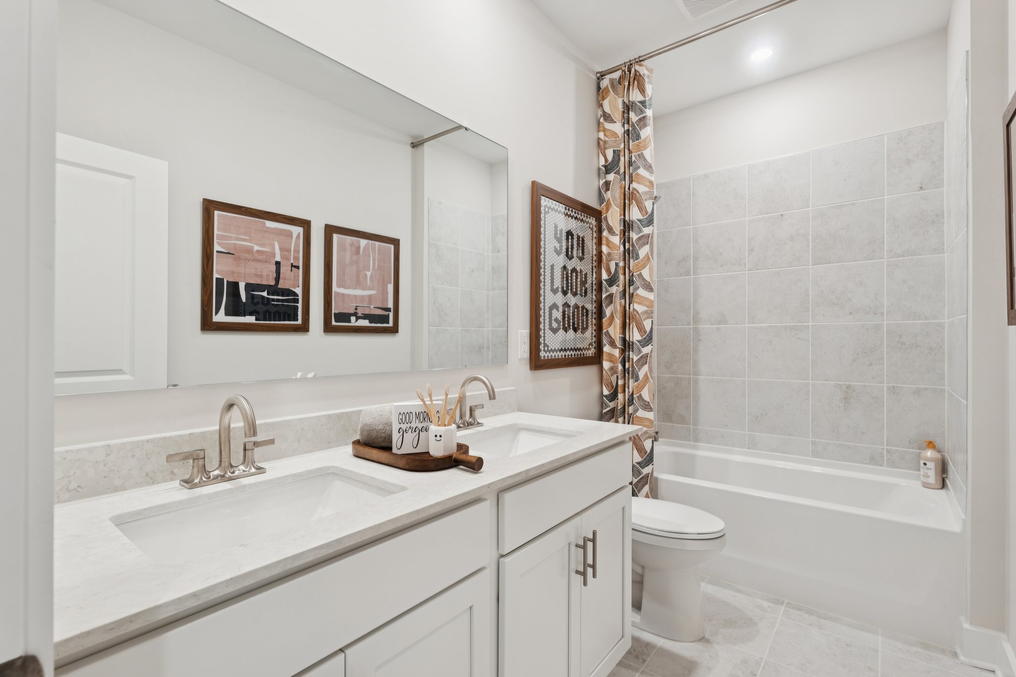A bathroom with a tub sink and toilet.