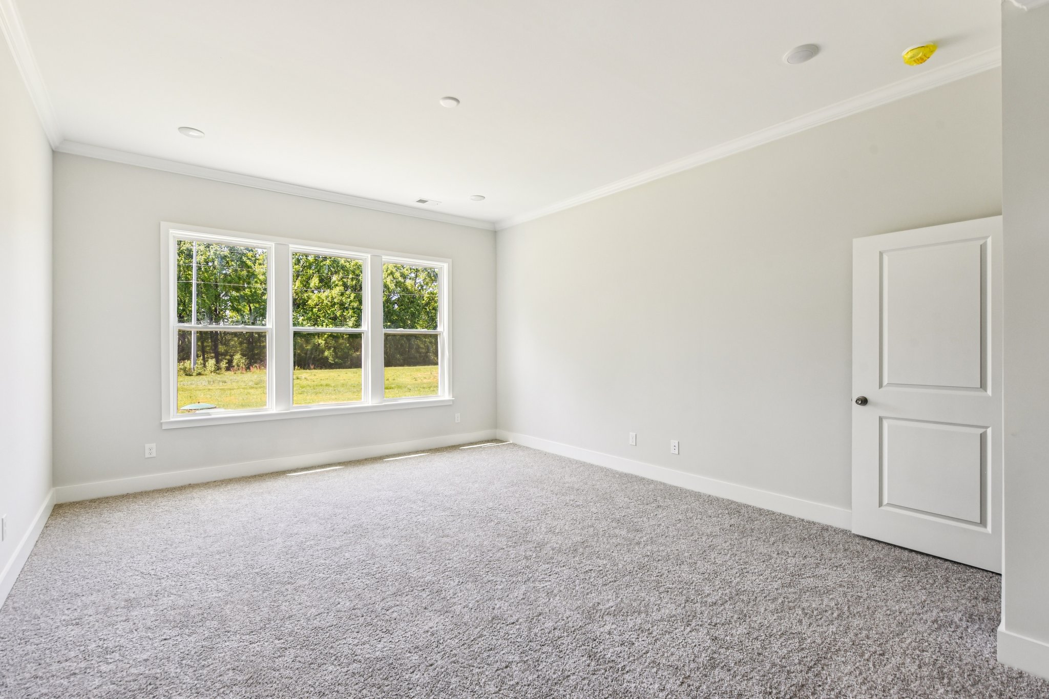 A room with a window and a door.