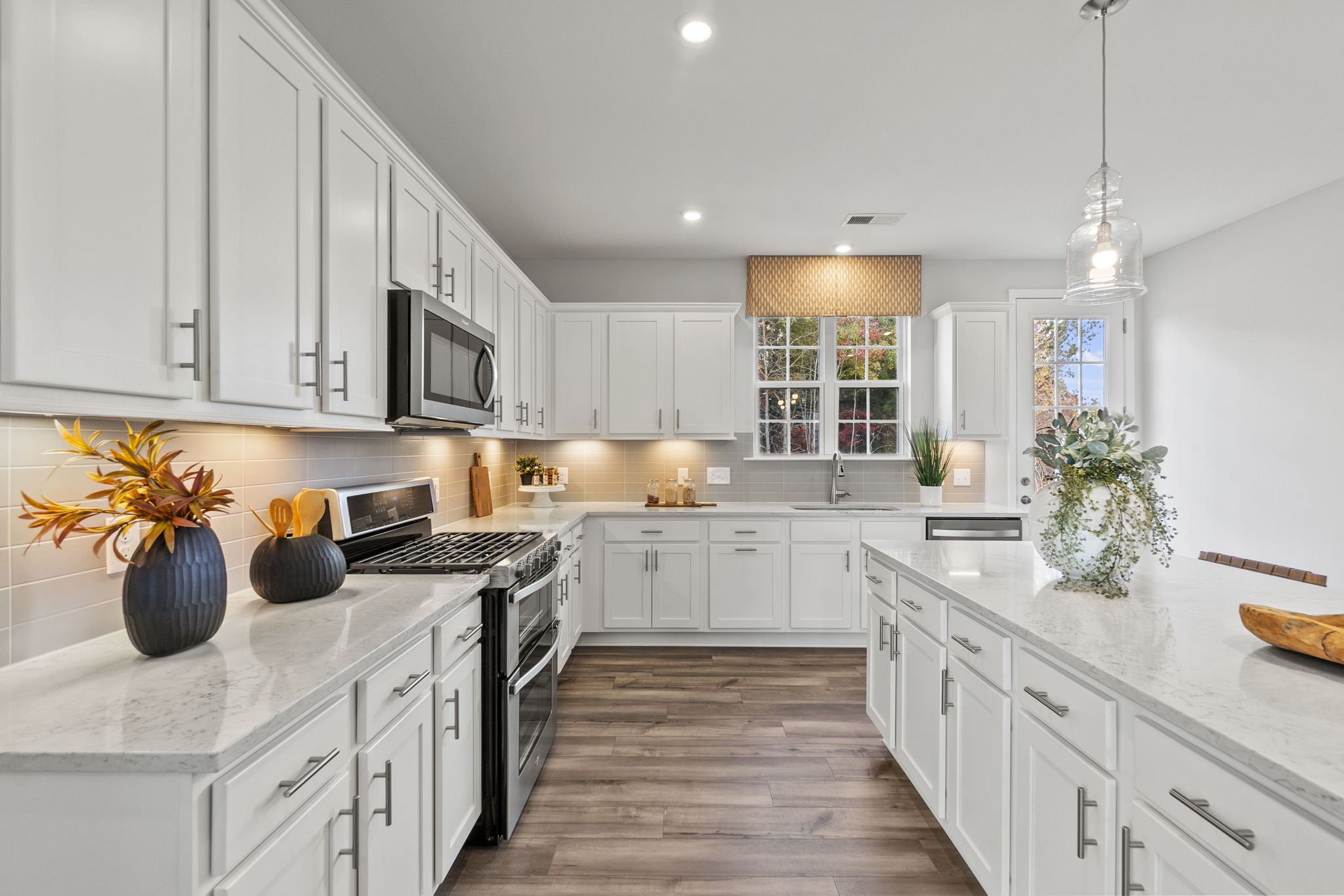A kitchen with white cabinets.