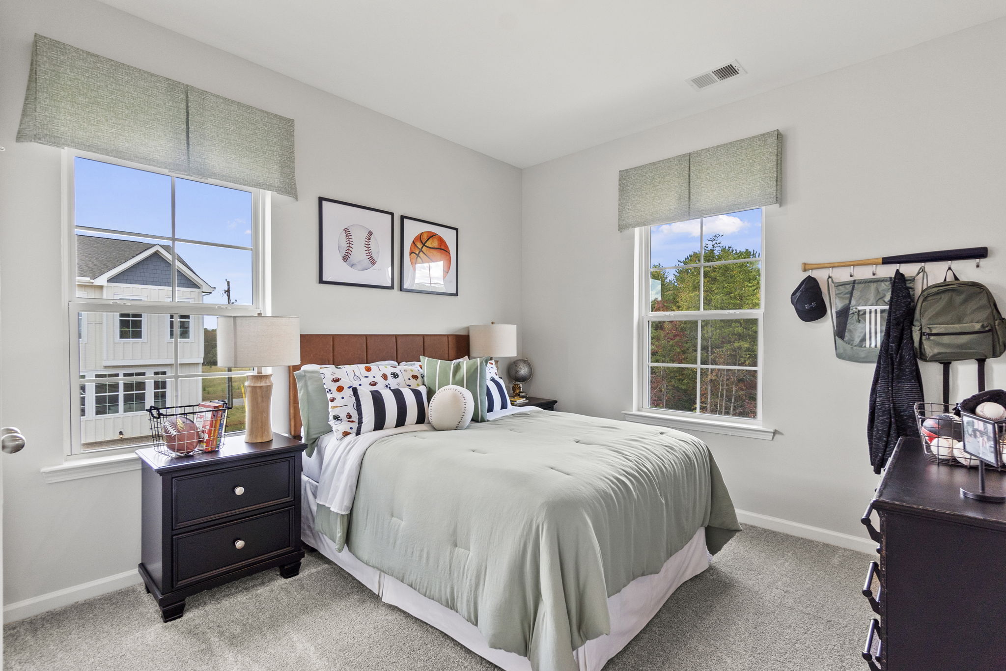A bedroom with a bed and a dresser.