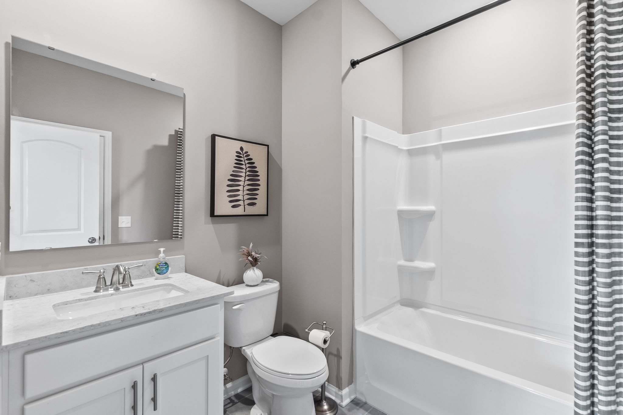 A bathroom with a tub toilet and sink.