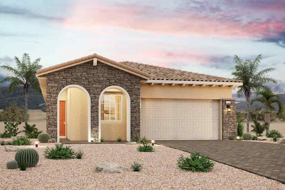 A house with a garage and palm trees.