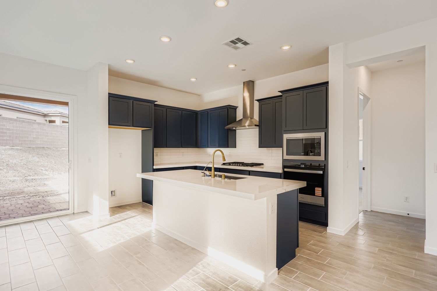 A kitchen with black cabinets.