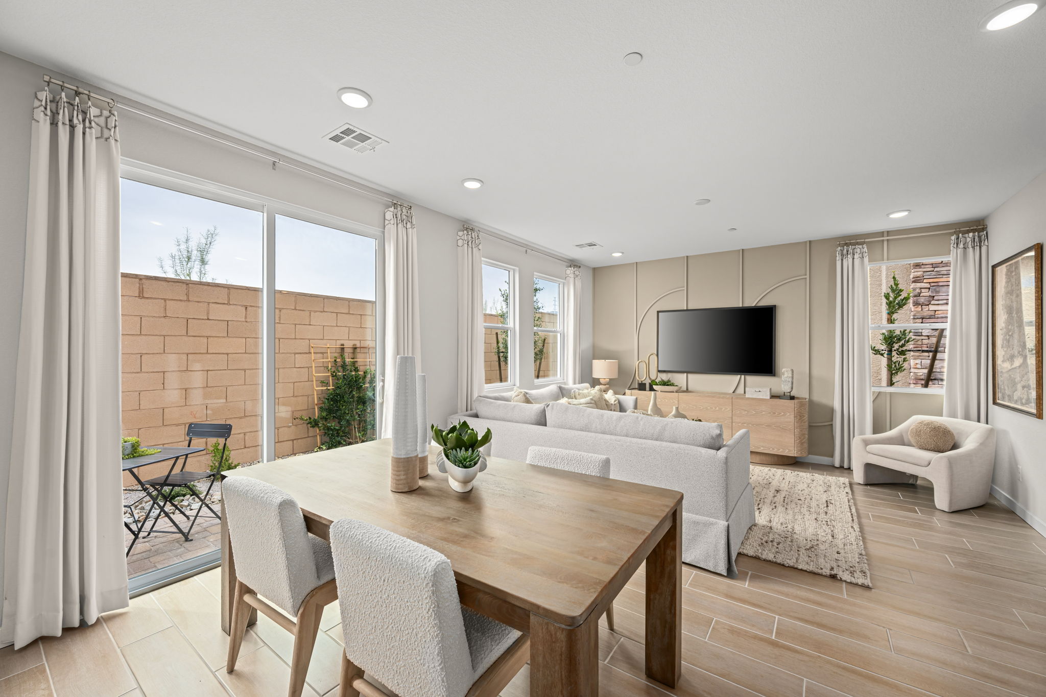 A living room with a large table and chairs.