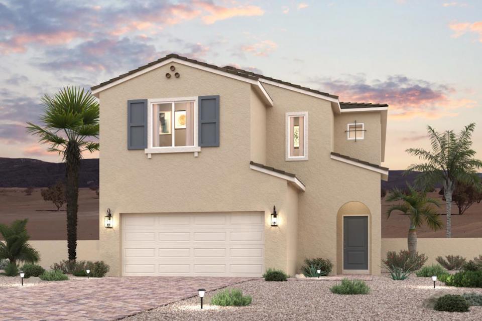 A house with a garage and palm trees.