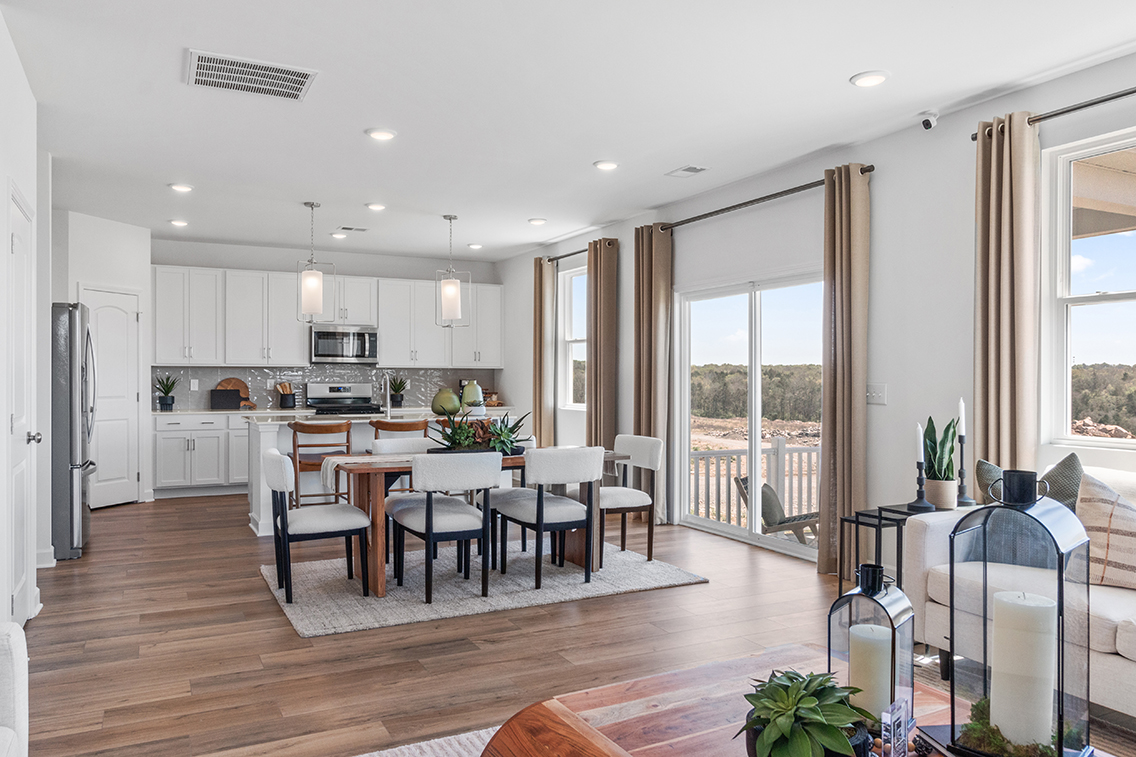 A kitchen with a dining table and chairs.