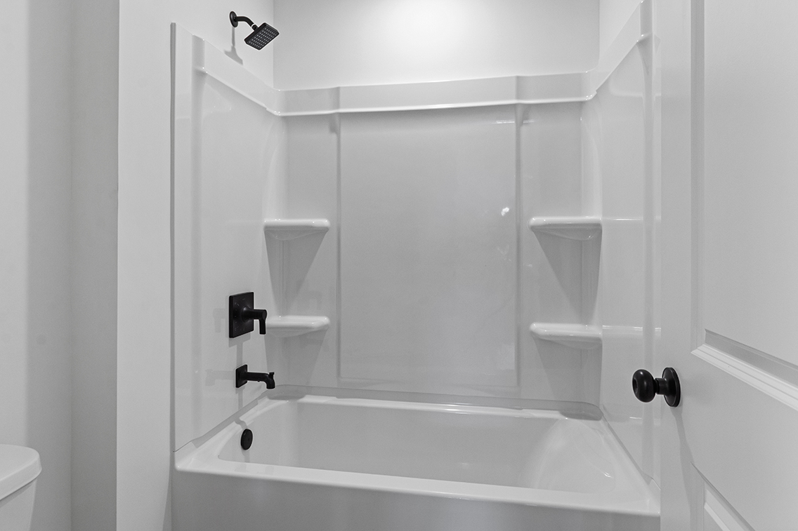 A bathtub with a glass door.