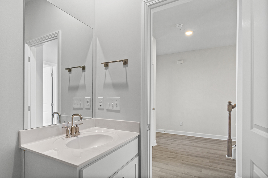 A bathroom with a large mirror.