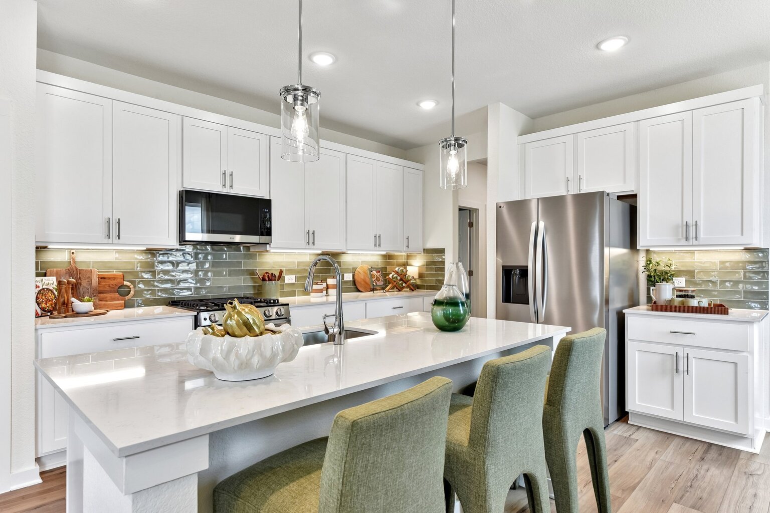 A kitchen with white cabinets.