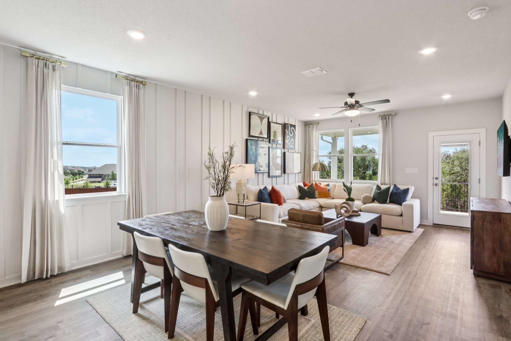 A large living room with a dining table and chairs.