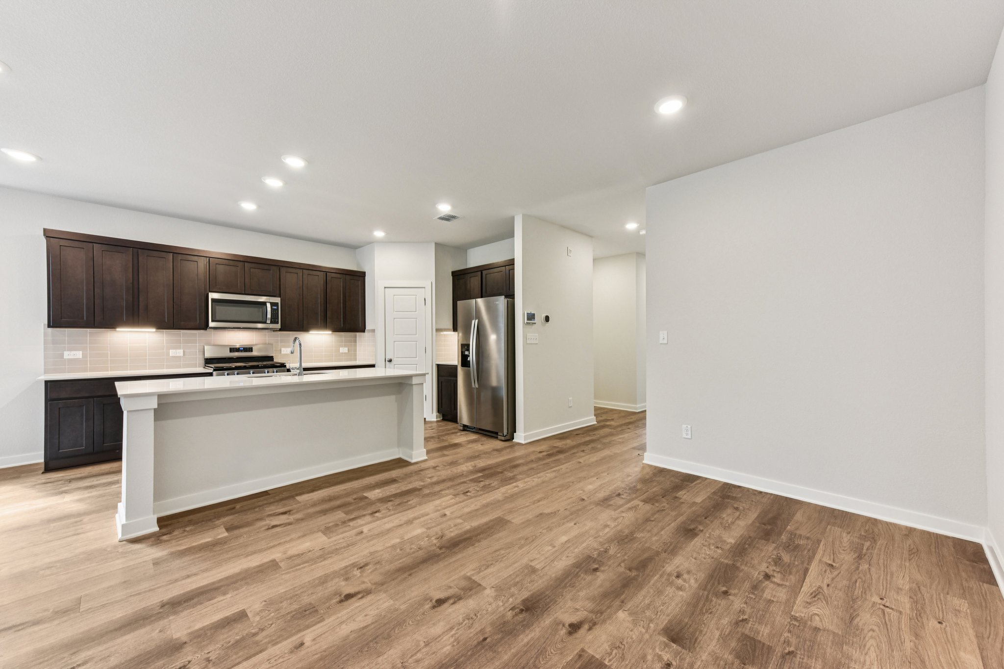 A kitchen with wooden floors.