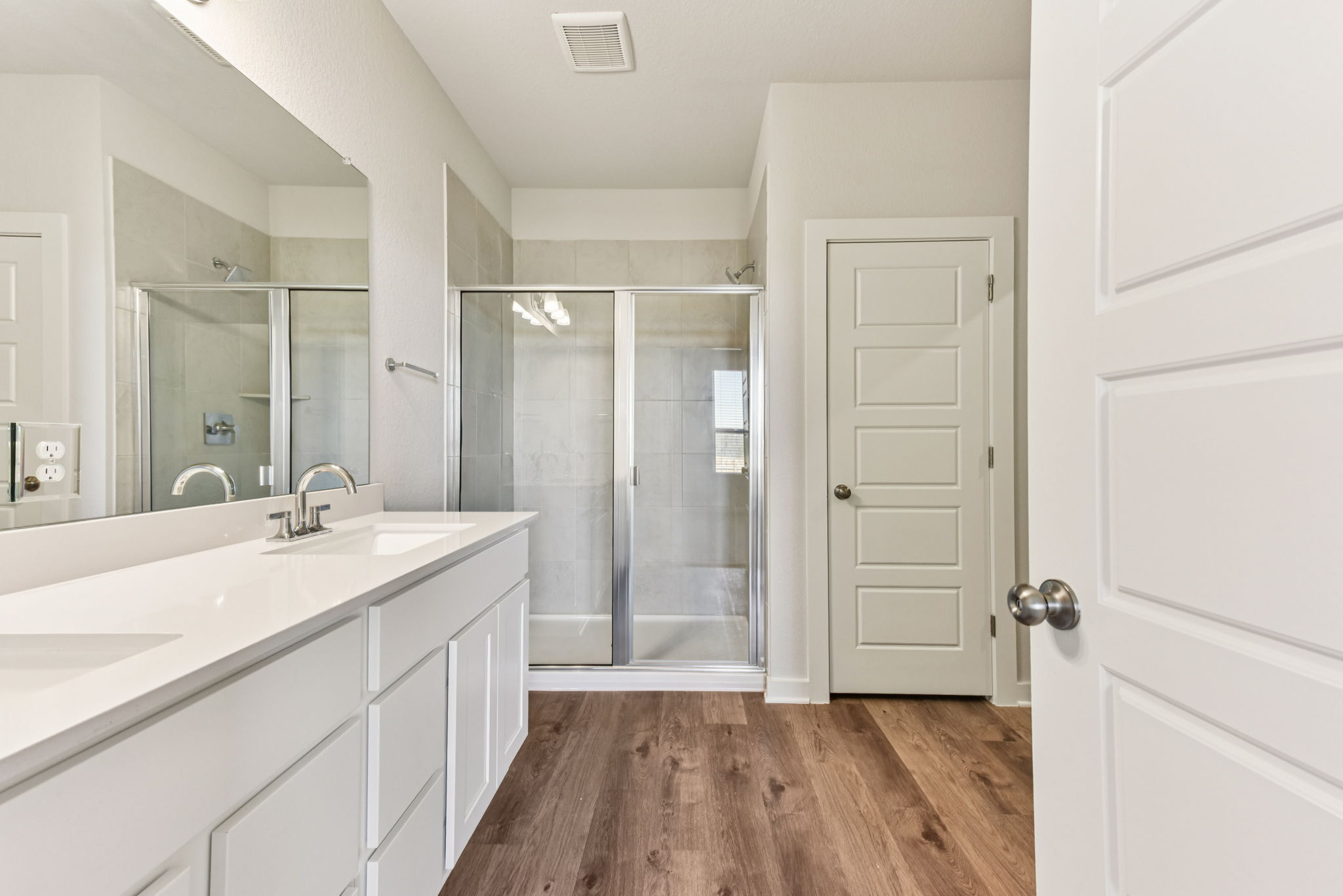 A bathroom with white cabinets.