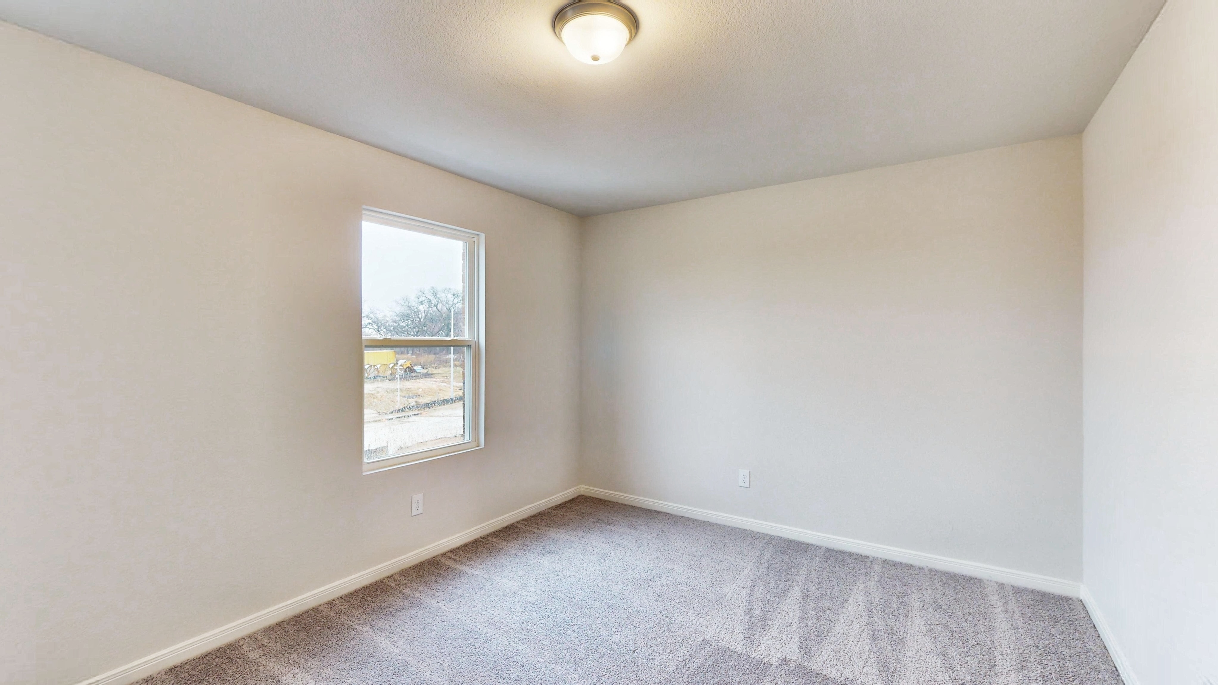 A room with a window and a carpet.