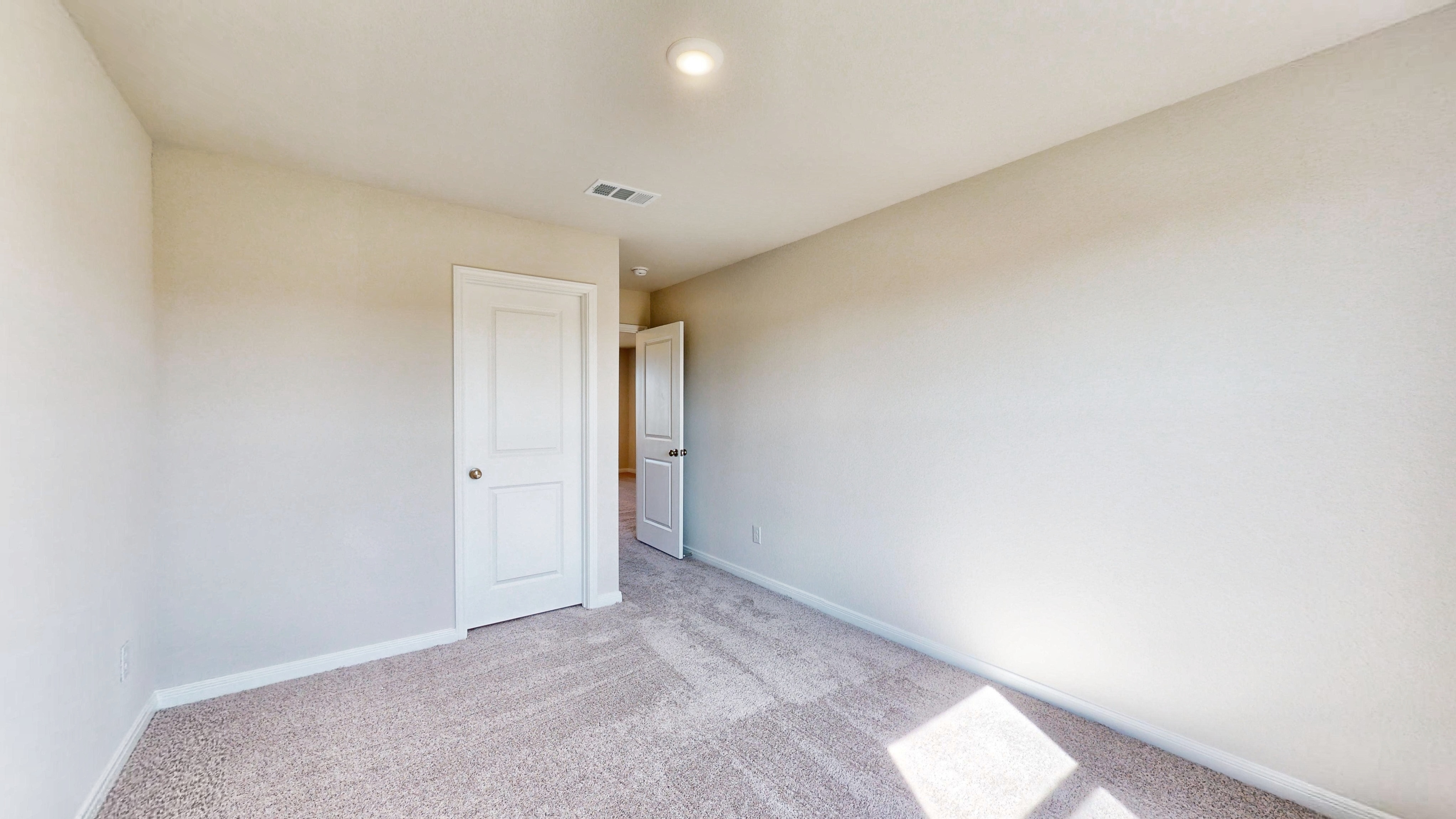 A hallway with white walls.