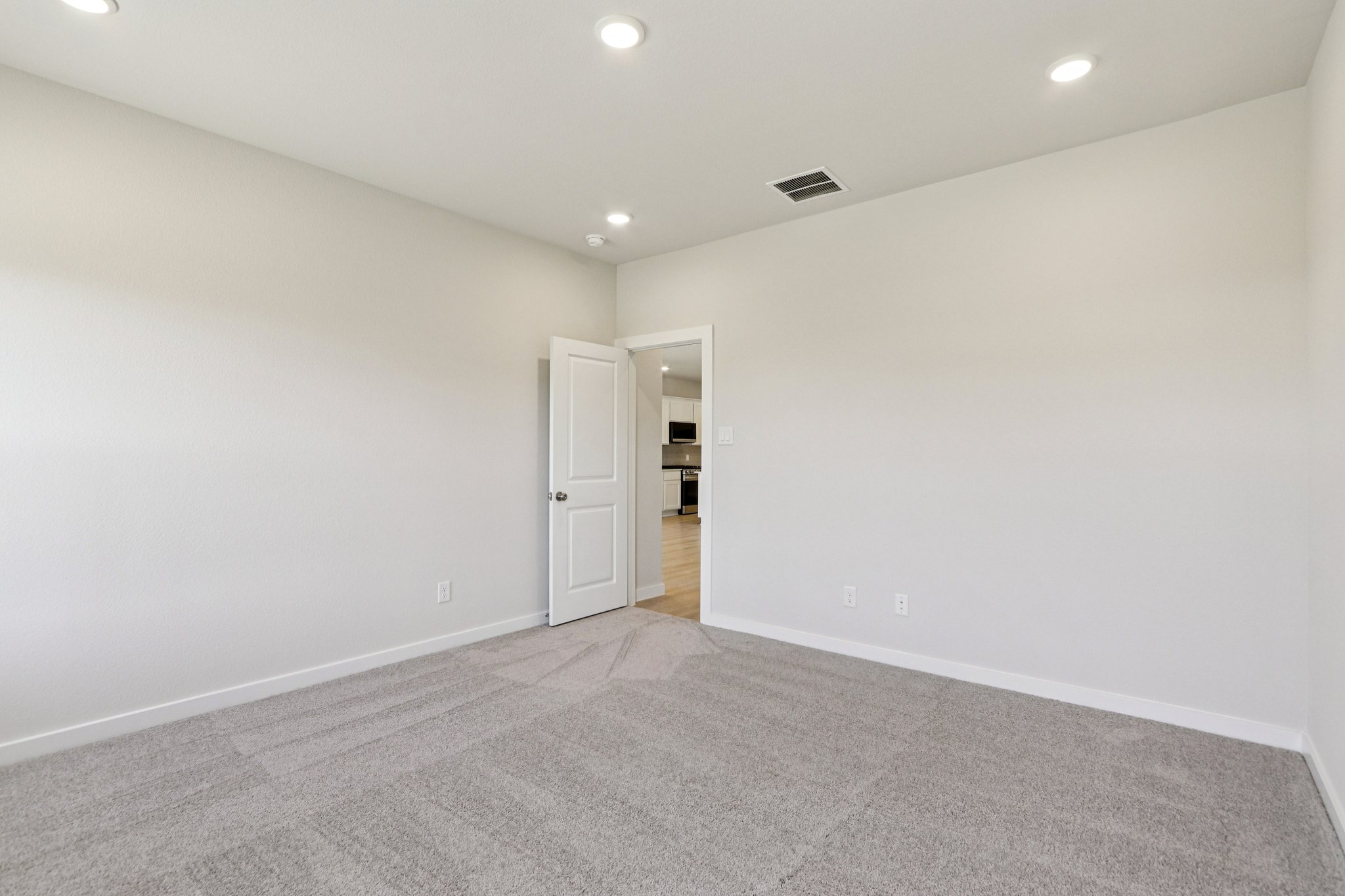 A hallway with white walls.