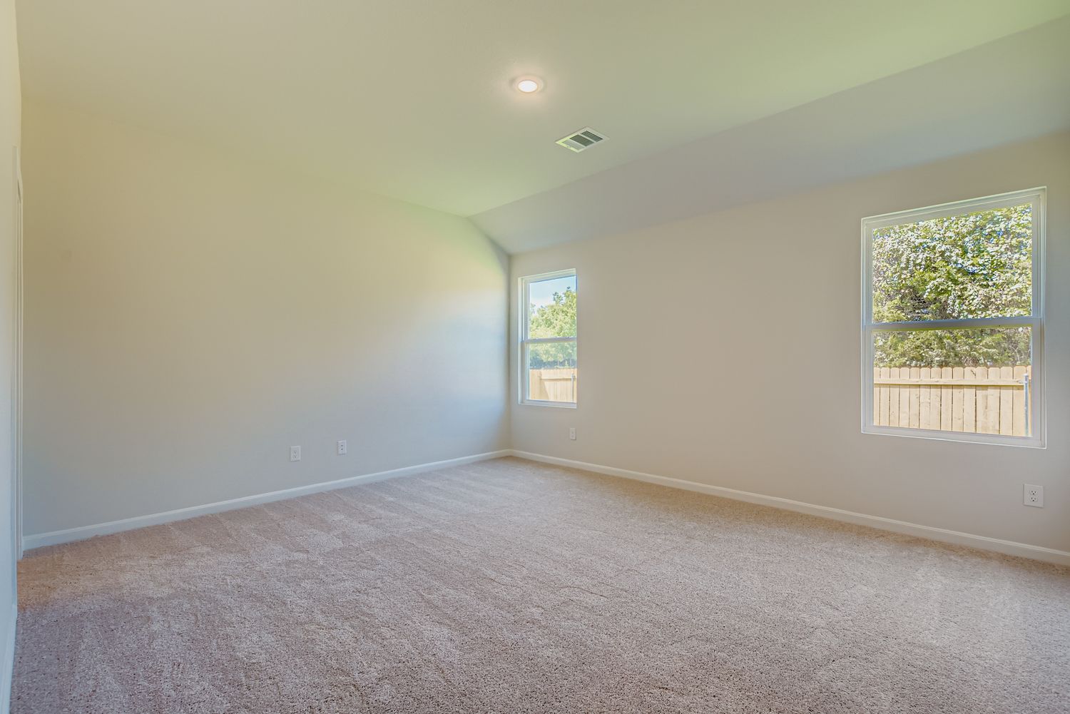 A room with windows and carpet.