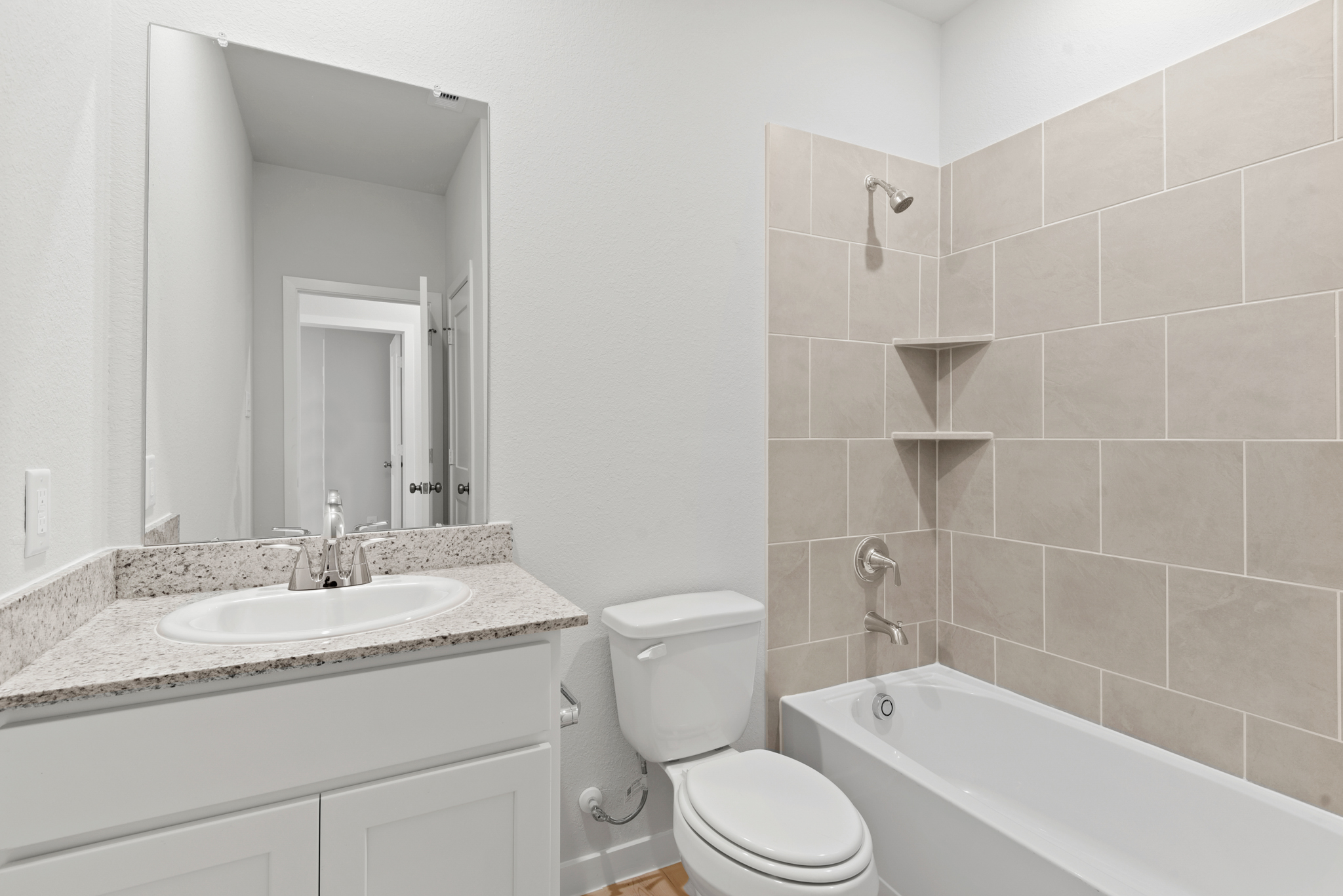 A bathroom with a tub sink and toilet.