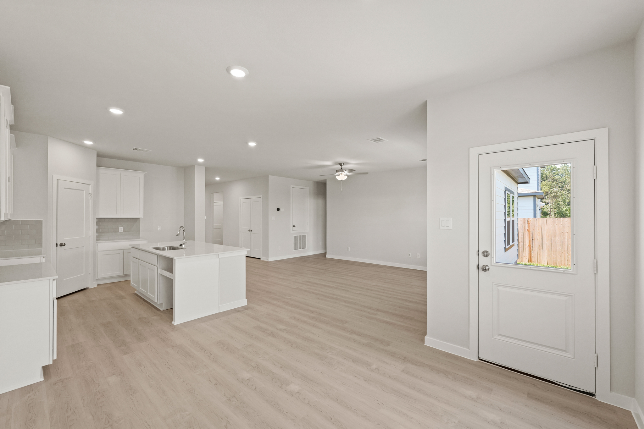 A large kitchen with white cabinets.
