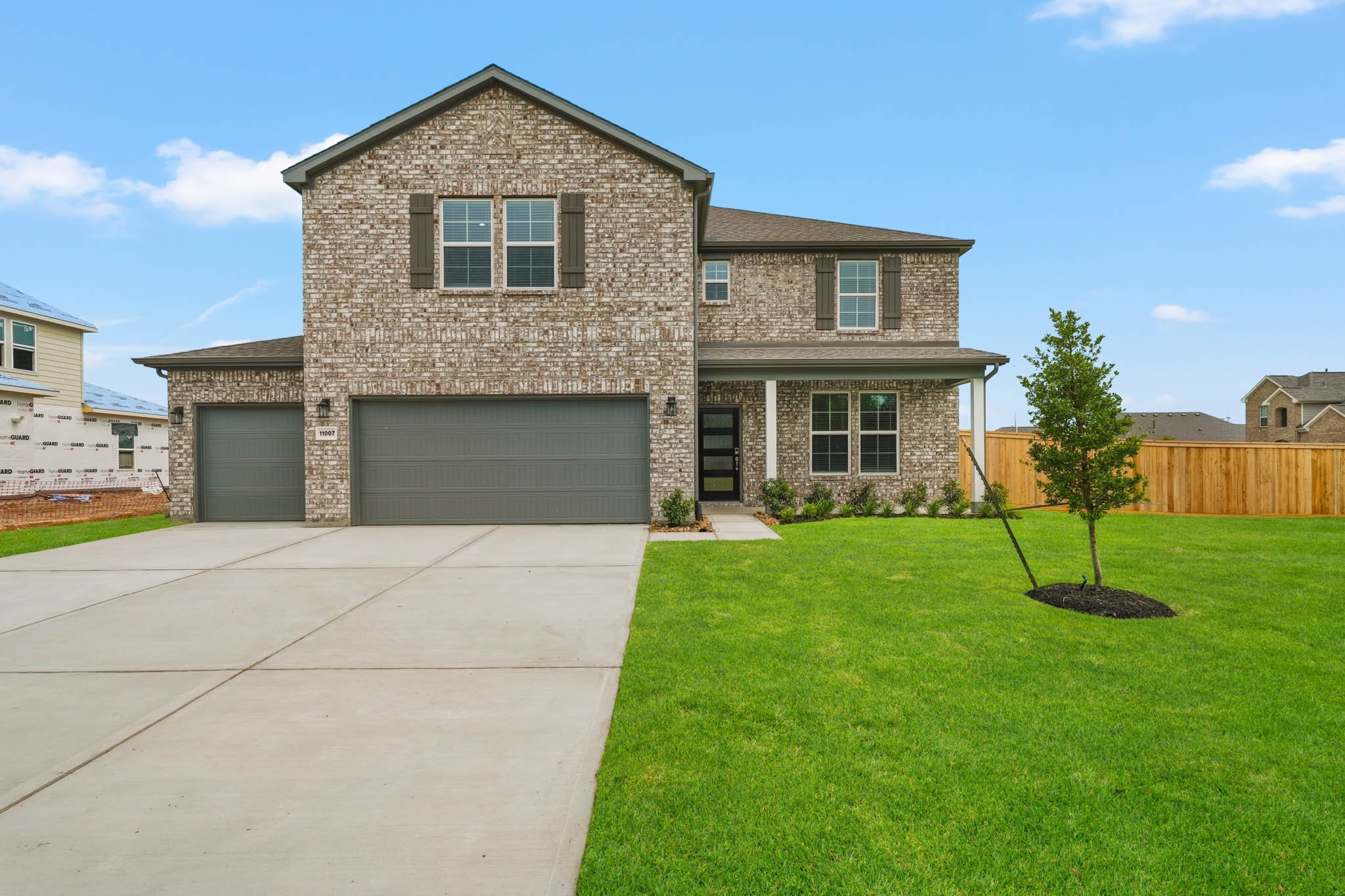 A house with a garage and a lawn.