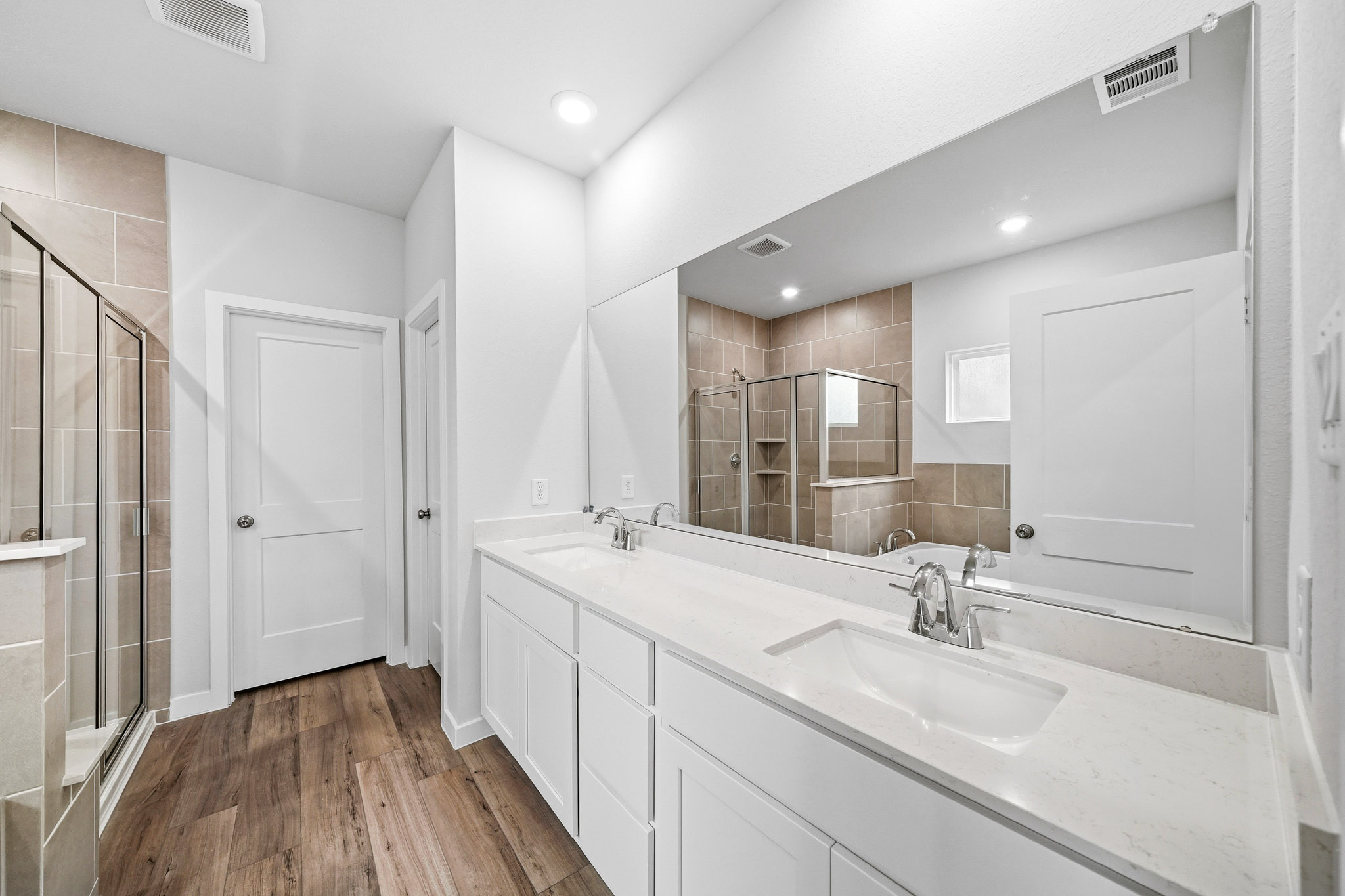 A bathroom with a large mirror.