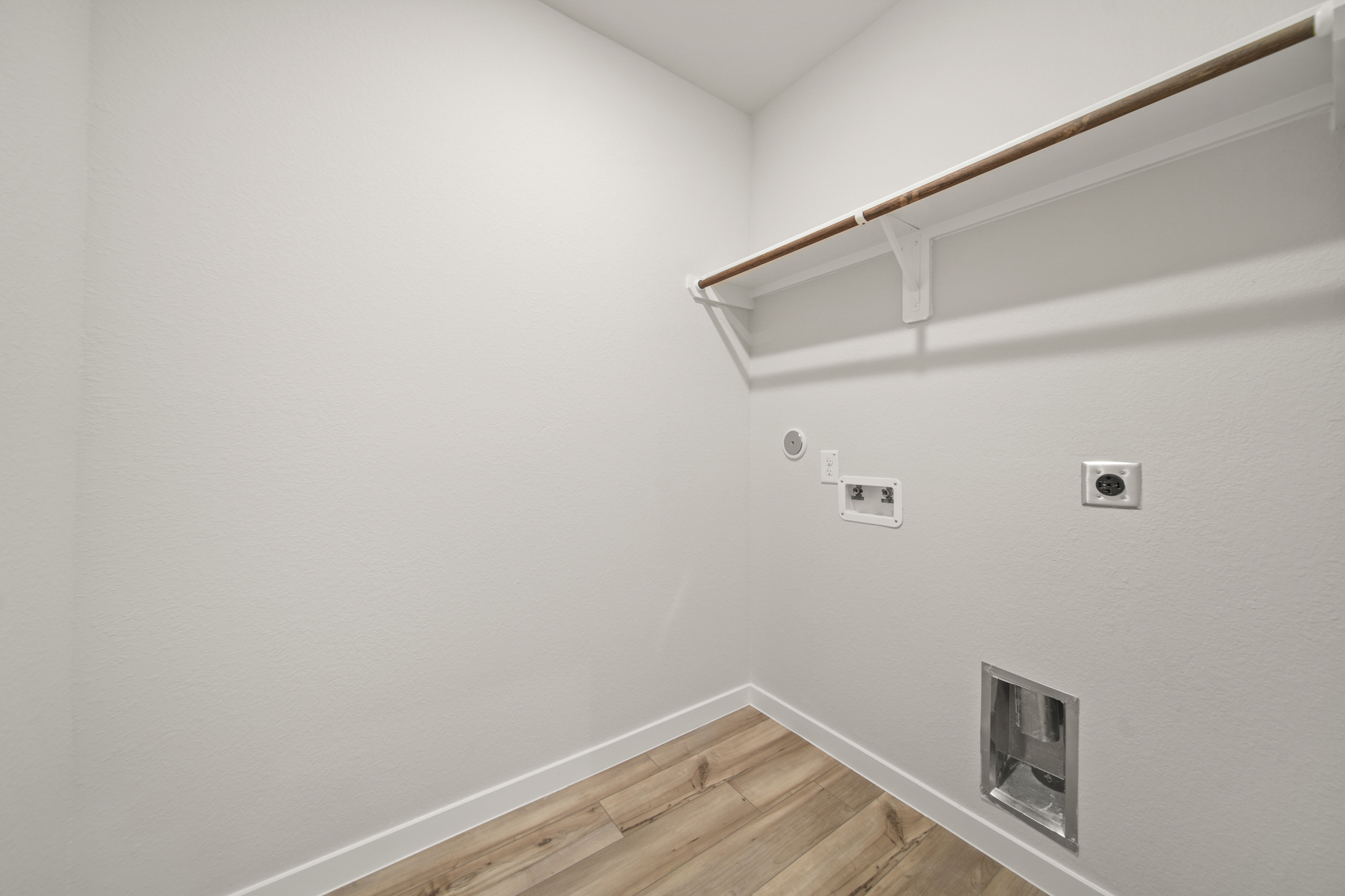 A room with white walls and a wood floor.