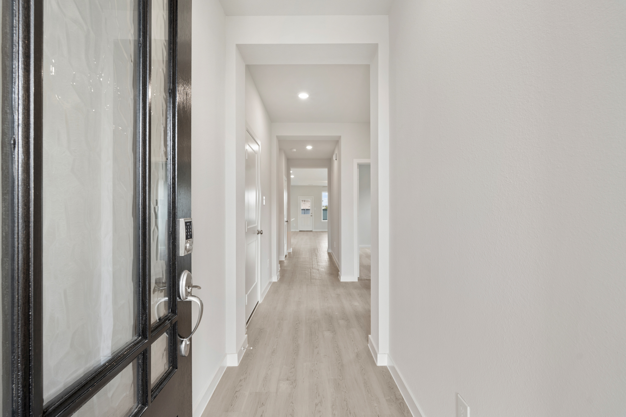 A hallway with glass doors.