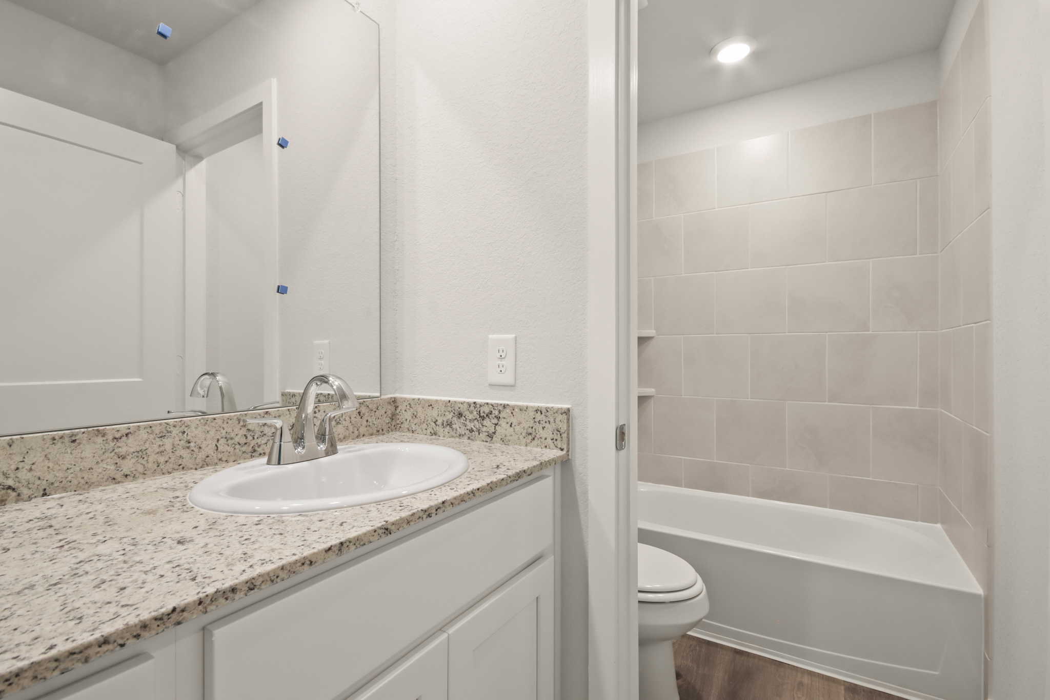 A bathroom with a marble countertop.