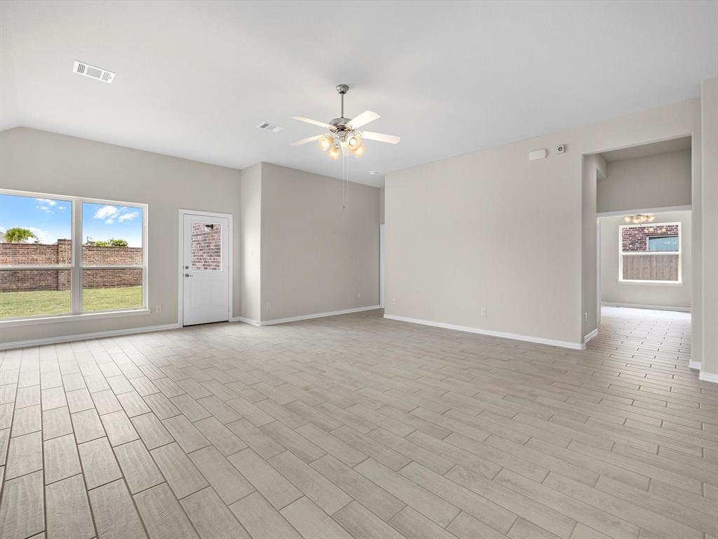 A room with a tile floor and a ceiling fan.